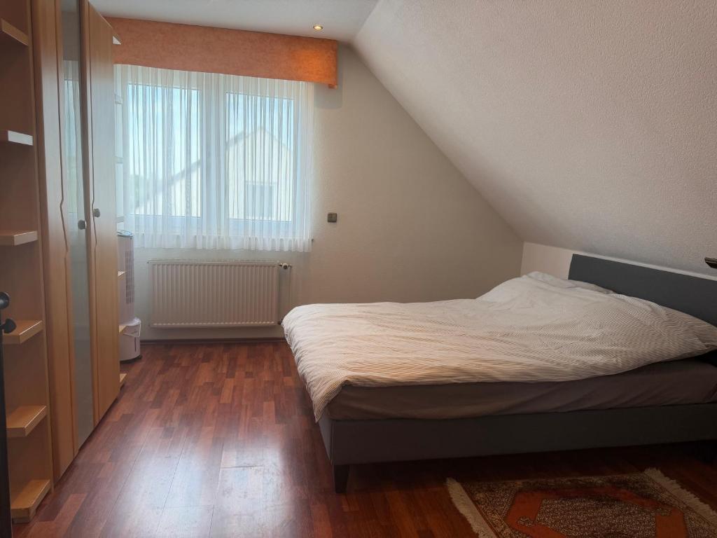 a small bedroom with a bed and a window at Burato`s Haus in Minden