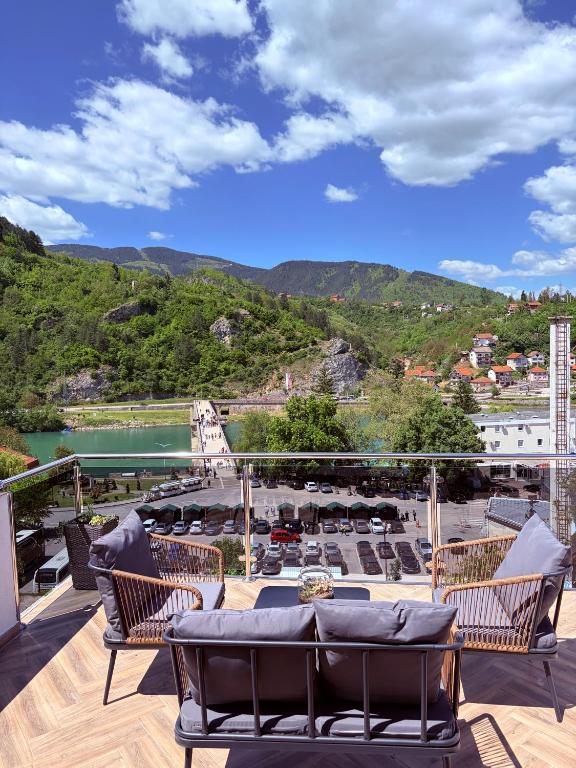 a balcony with couches and a view of a mountain at Luna Apartman in Višegrad