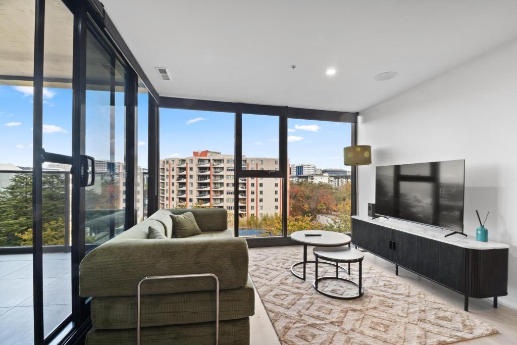 a living room with a couch and a table at Premium 2BR Braddon, Marriott Amenities in Braddon