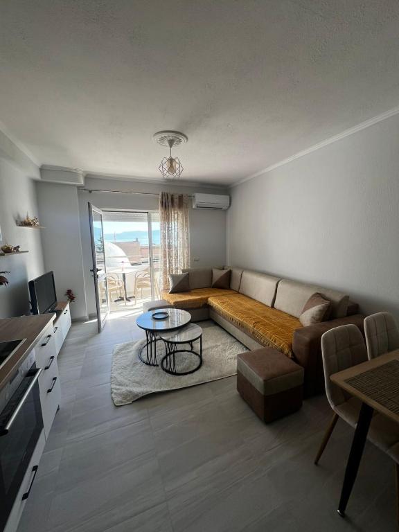 a living room with a couch and a table at InnPogradec Center in Pogradec
