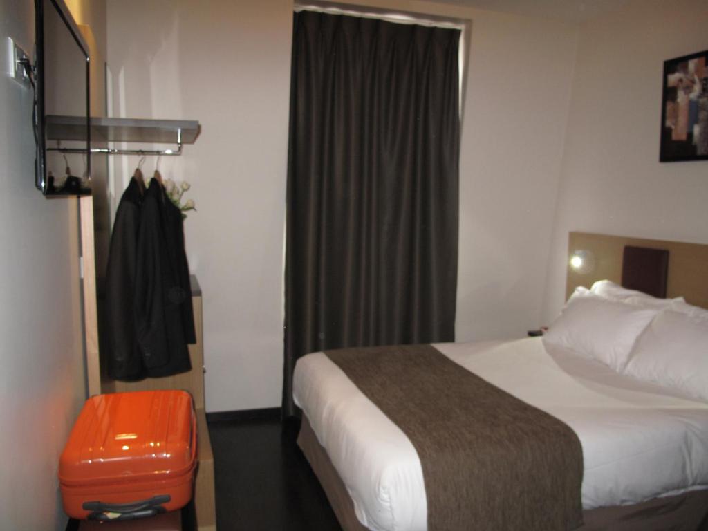 Voodi või voodid majutusasutuse Source Hôtel toas