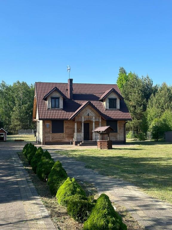 a house with a tiled roof on a yard at Summer house near the forest in Dybki