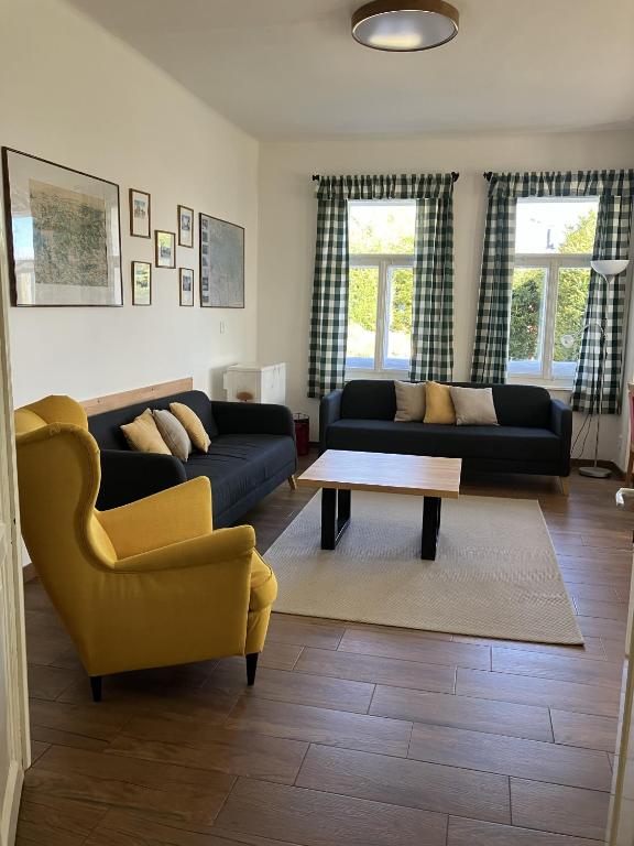 a living room with two couches and a coffee table at Penzion Hají in Janov nad Nisou