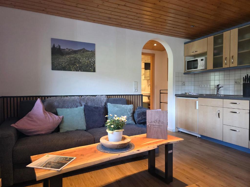 a living room with a couch and a table at Walser Auszeit in Riezlern