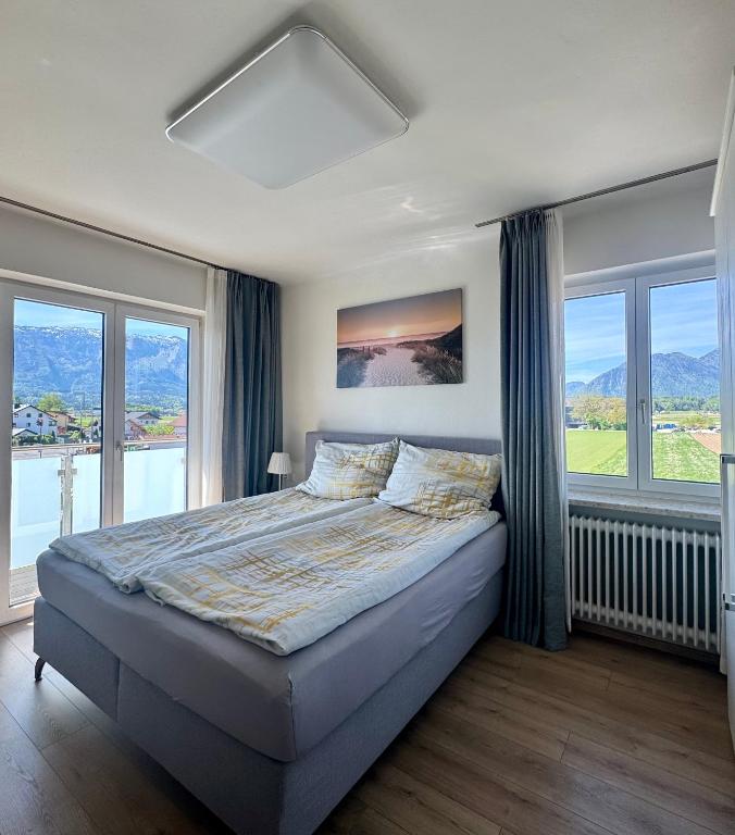 a bedroom with a large bed with windows at Apartment Birnbaum in Wals