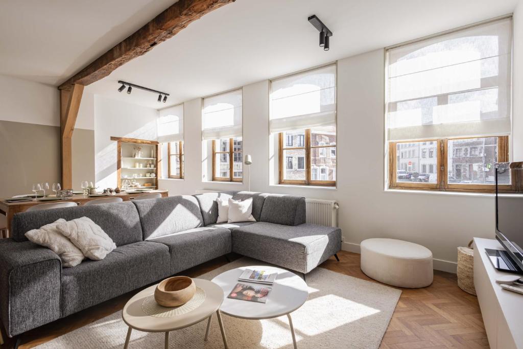 a living room with a couch and a table at Vakantiewoning Gast in Borgloon