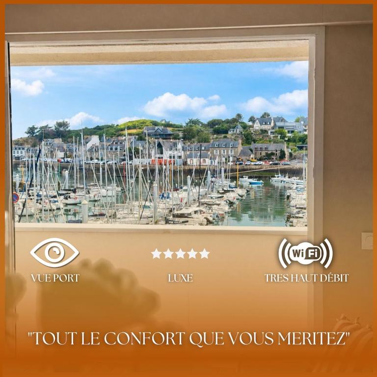 a window with a view of a marina at Elegance Bretonne in Pléneuf-Val-André