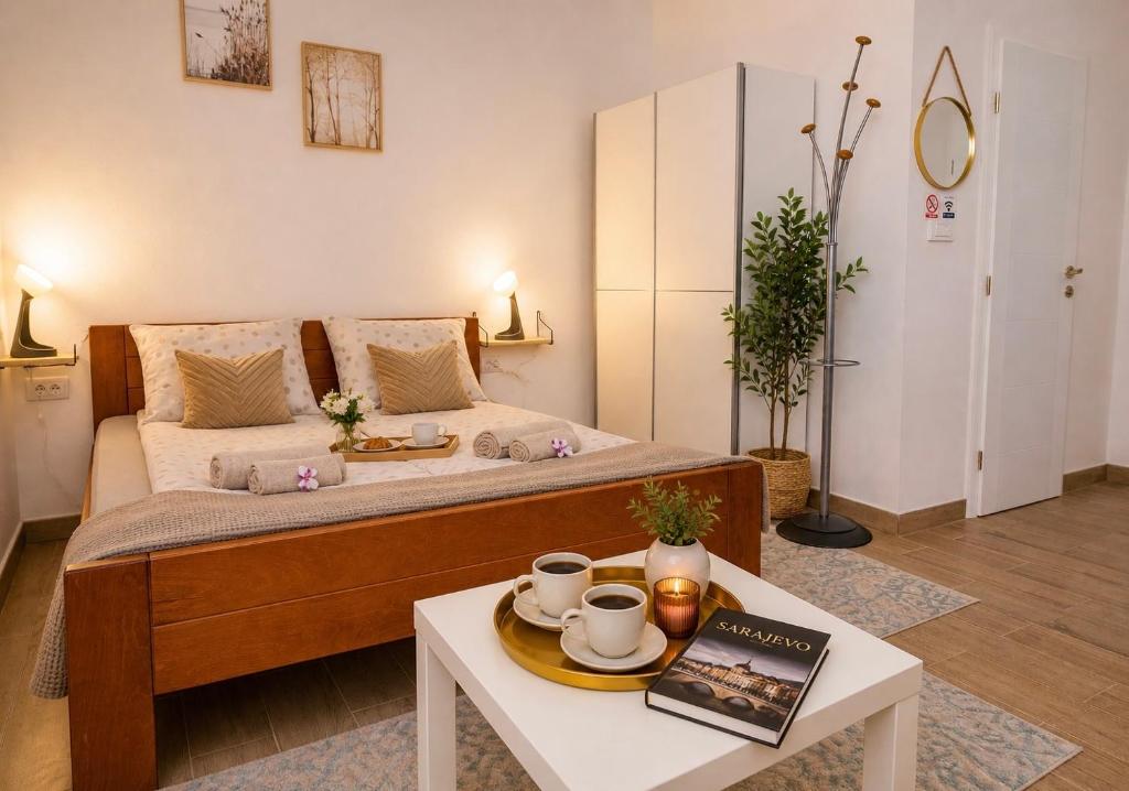 a room with a bed and a table with a coffeeucer at Charm Apartment-Cathedral area-Self Check-in in Sarajevo