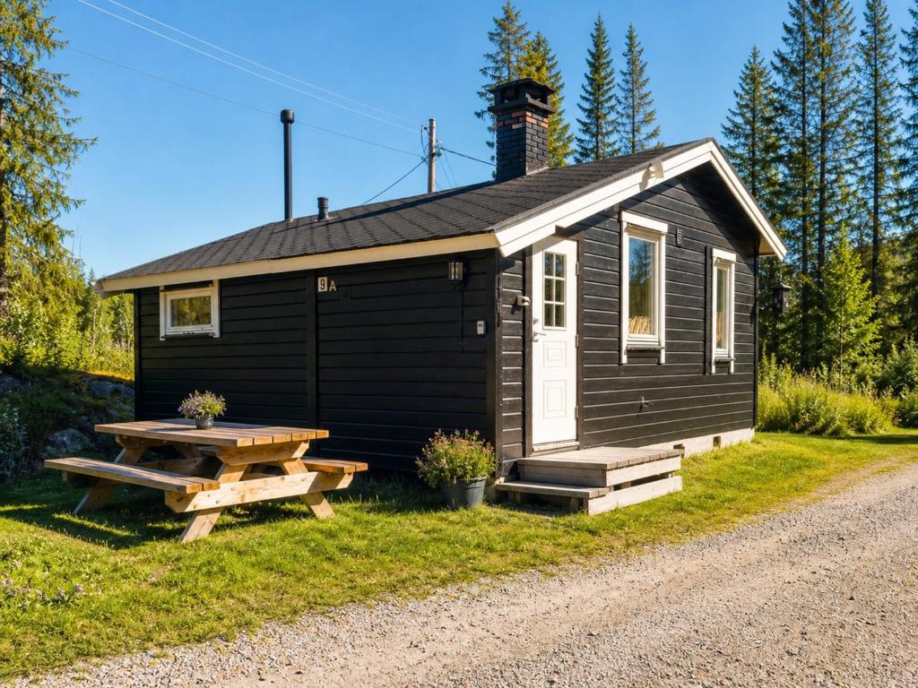 a small cabin with a picnic table in front of it at Koselig Hytte i Hemsedal with outdoor Sauna in Hemsedal