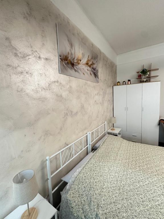 a bedroom with a bed and a wall at Central City Apartment of Asti in Asti