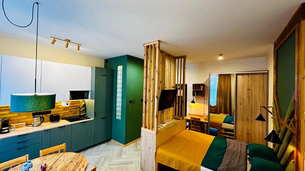 a bedroom with green walls and a bed and a table at City Vibe Studio in Poznań