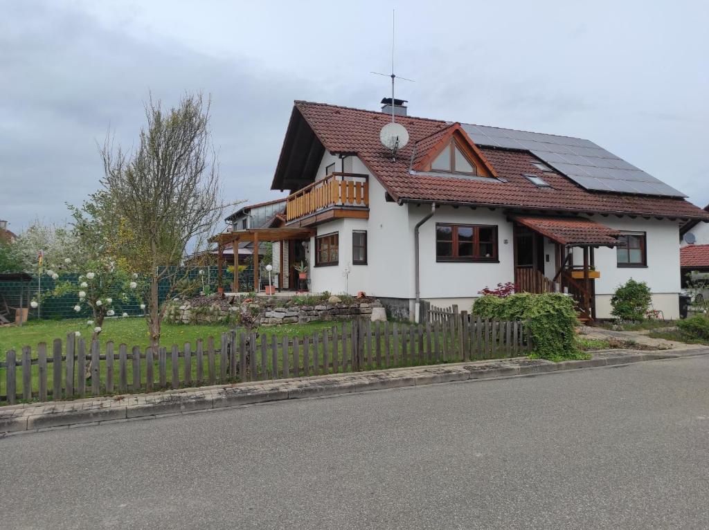 a white house with a wooden fence on the side of the road at Schöner Wohnen in Rheinau