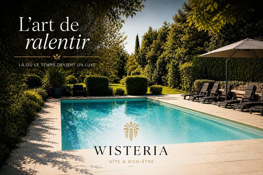 a swimming pool with chairs and an umbrella at Wistéria #Piscine #Terrasse privée #Route des vins in Azé