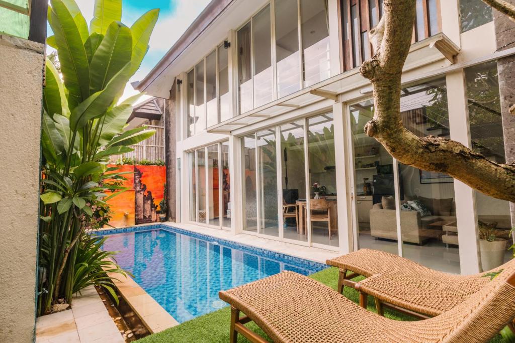 an exterior view of a house with a swimming pool at Modern Villa near Seminyak & Canggu, Large Pool in Kerobokan
