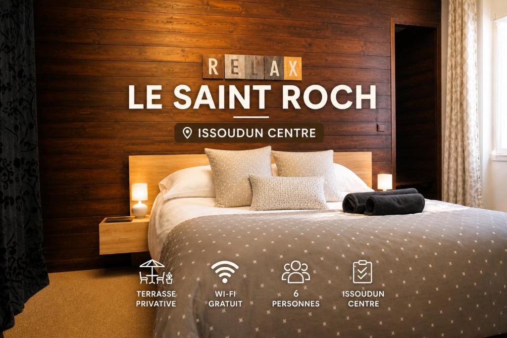 a hotel room with a bed with a sign that reads renal le saint rock at Le Saint-Roch Issoudun - Charm & Private Terrace in Issoudun