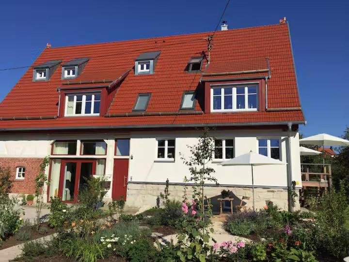 a large white house with a red roof at Lerchenhof in Balingen