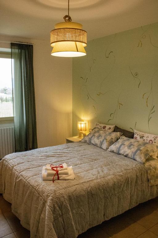 a bedroom with a large bed with towels on it at Ai tre camini in Adro