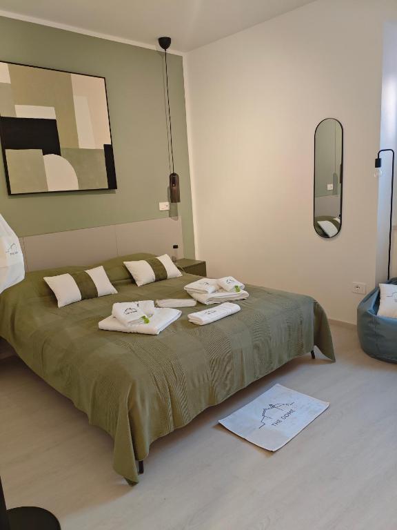 a bedroom with a large bed with towels on it at The Dome in Orbetello