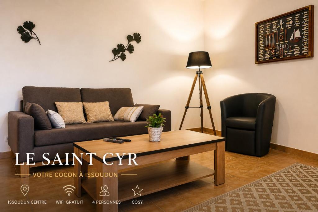 a living room with a couch and a chair at Le Saint-Cyr Issoudun - Cosy, Spacious & Downtown in Issoudun
