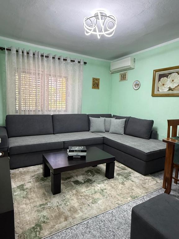 a living room with a couch and a coffee table at Sweet Escape in Shkodër