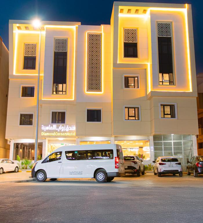 a white van parked in front of a building at Zawaya Almasia Hotel 2 in Medina