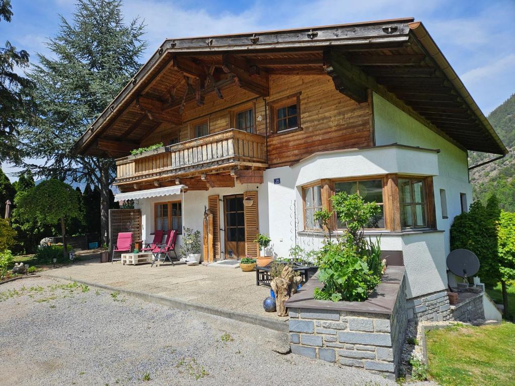 a house with a dog standing in front of it at Ferienwohnungen Inka in Sautens