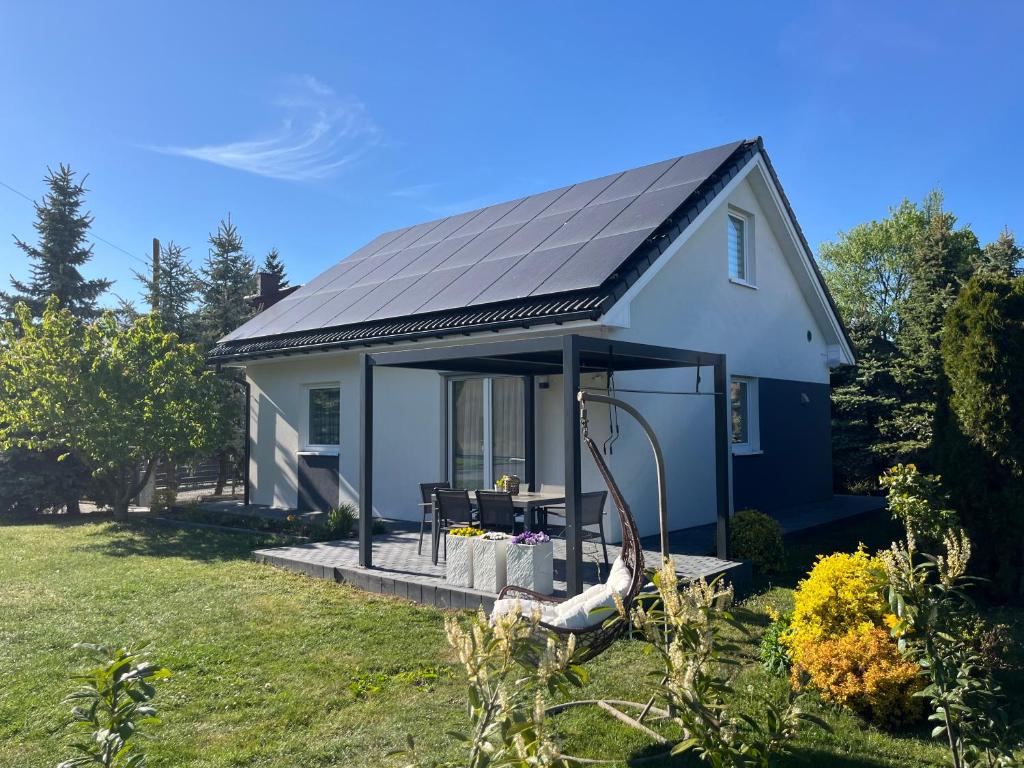 a small white house with a solar roof at Opole Calm House in Opole