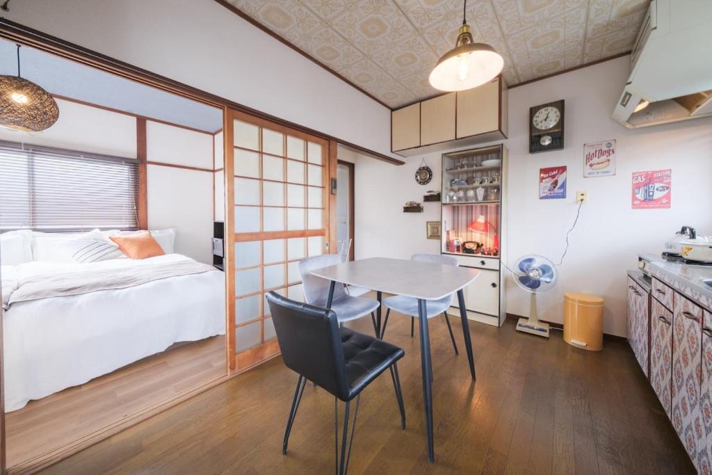 a small room with a table and a bed at KEI HOUSE Yamato 201 in Yamato