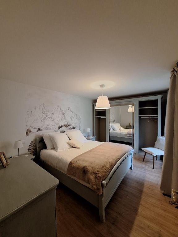 a bedroom with a large bed in a room at Chambre d hotes Spa montagne in Laruns