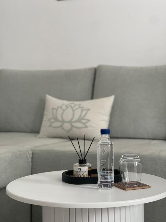 a white coffee table with a bottle of water on it at Appart laouina in El Aouina Station