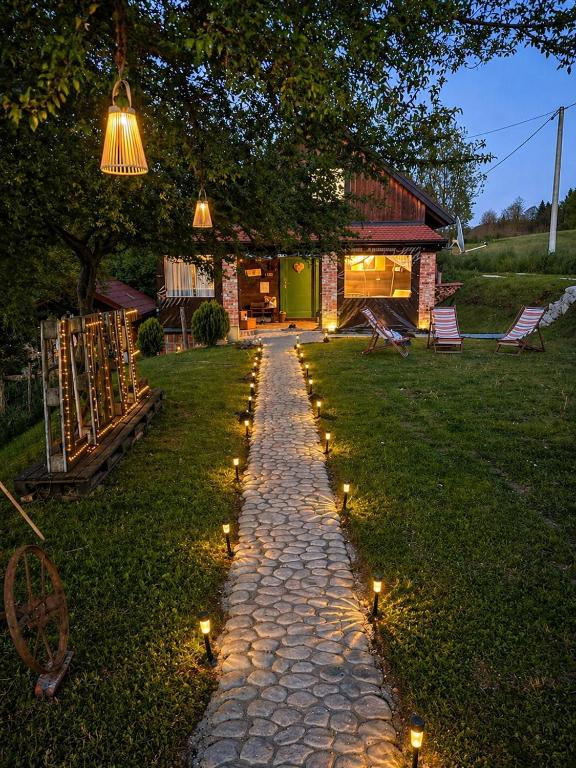 a stone pathway with lights in the grass at Kuća za odmor Kleopatra in Netretić