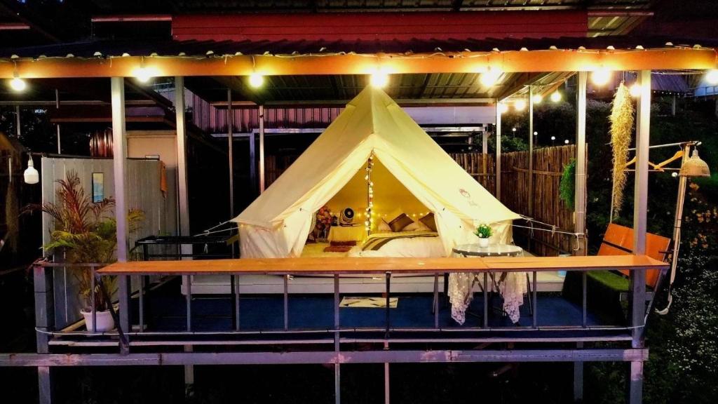 a circus tent on a stage with lights at มองวิวภูชี้ฟ้า รีสอร์ท in Ban Seng Choi