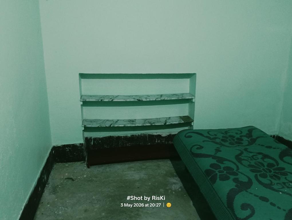 a small room with a shelf and a bed at Quarter 2355 in Bokāro