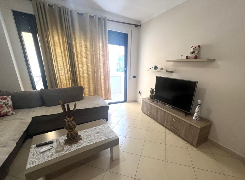 a living room with a couch and a flat screen tv at B2 Apartment 4 in Kashari