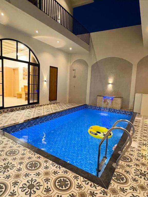a large swimming pool in a house with a swimming pool at Luxury private pool villa for families & groups in Ujjain
