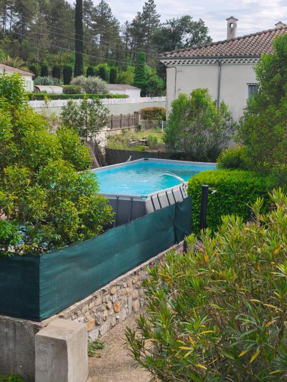 an overhead view of a swimming pool in a garden at L oxygène ardéchois gîte 3 in Ruoms
