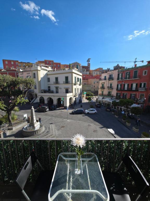 a vase with a flower on a table on a balcony at Casa Quattro Cannelli in Pozzuoli