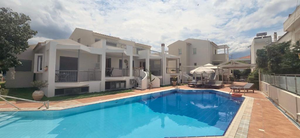 a large house with a swimming pool in front of it at Νηρηίδες Apartments Studios in Kyparissia