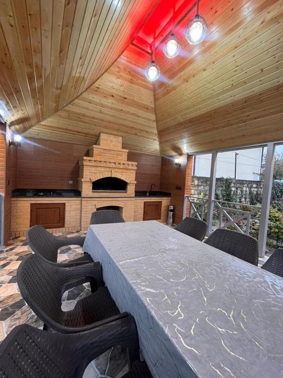 a dining room with a large table and chairs at Gusar bungalow in Qusar
