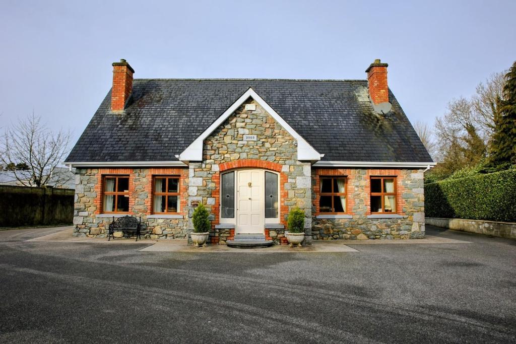 a small stone house with a white door at Laurel Lodge in Virginia