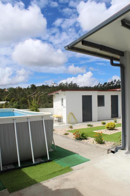 a view from the backyard of a house with a pool at Casa Barbeiro in Pombal