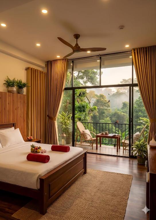 a bedroom with a bed and a large window at Green cottage Ella in Ella