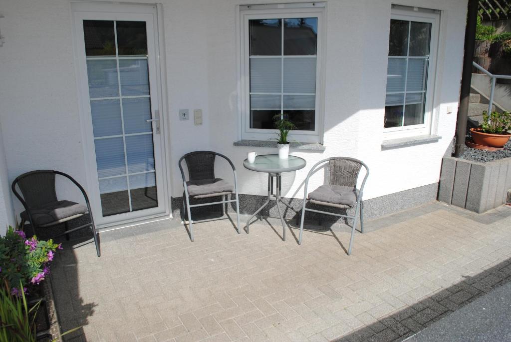 a patio with a table and chairs on a porch at Apartment Julia in Bad Orb