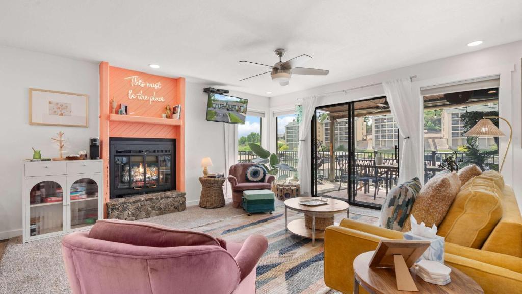 a living room with a couch and a fireplace at Daylight Cove Lakefront Chic in Lake Ozark