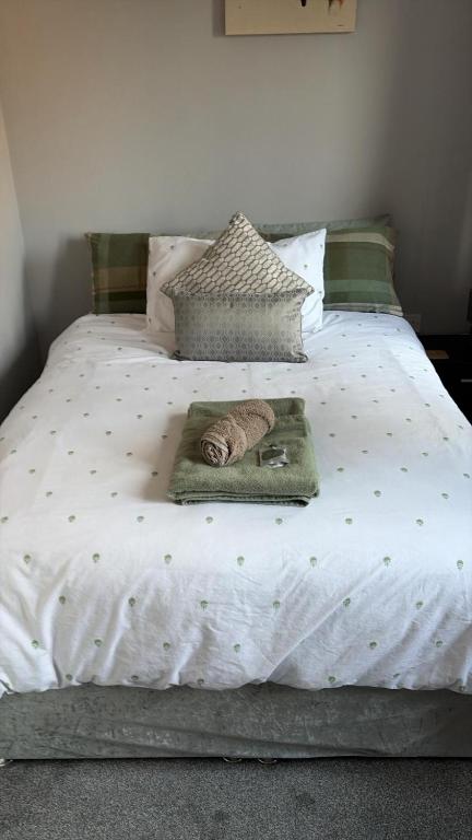 a bed with a blanket and a towel on it at Fieldside View in Tydd Saint Giles