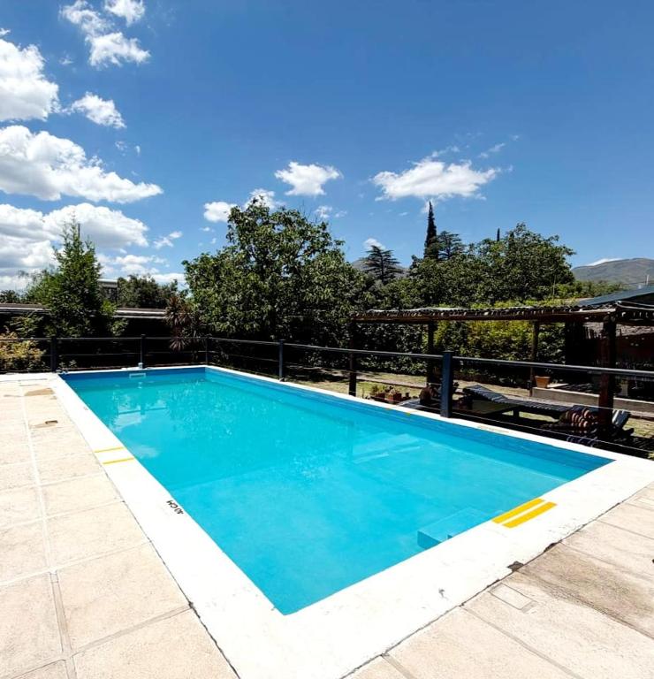 a blue swimming pool on a balcony with a blue sky at GuardiaPiemontese Aparts in Capilla del Monte