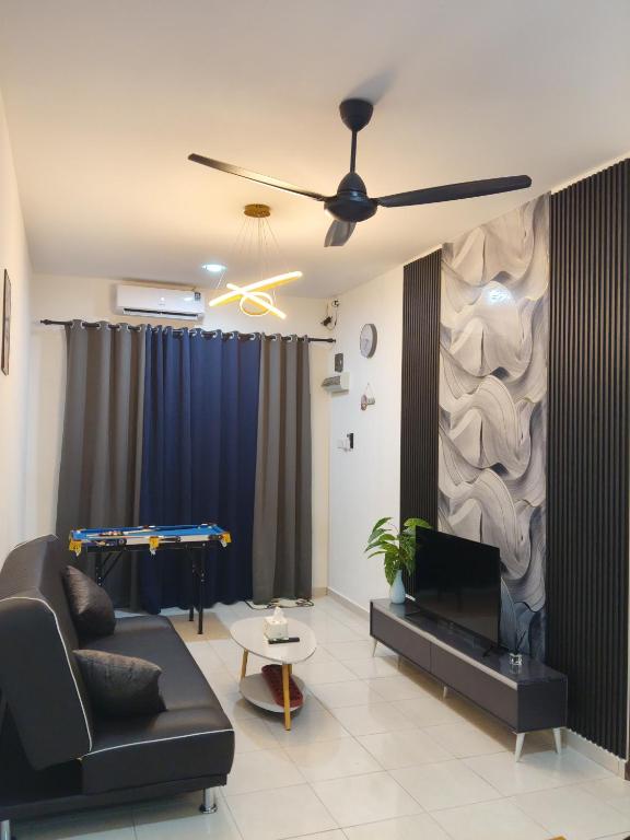 a living room with a couch and a ceiling fan at Yashz Guest House in Port Dickson