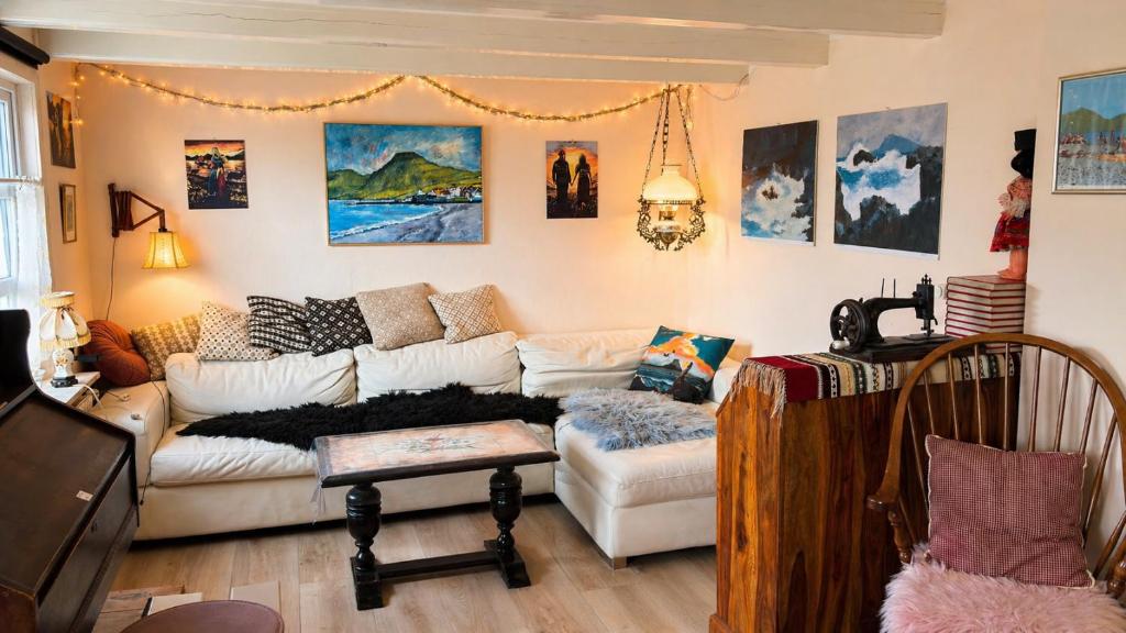 a living room with a couch and a table at Beachhouse Syðrugøta in Syðrugøta