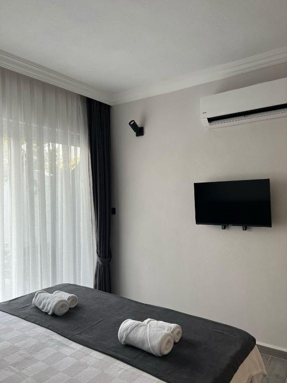 a bedroom with a bed with two pillows on it at Lilia Homes in Fethiye