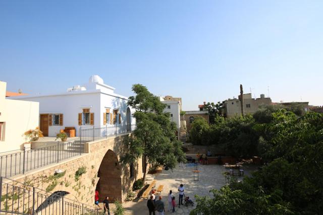 a group of people walking down a street next to a building at Villa Paradiso Batroun in Batroûn